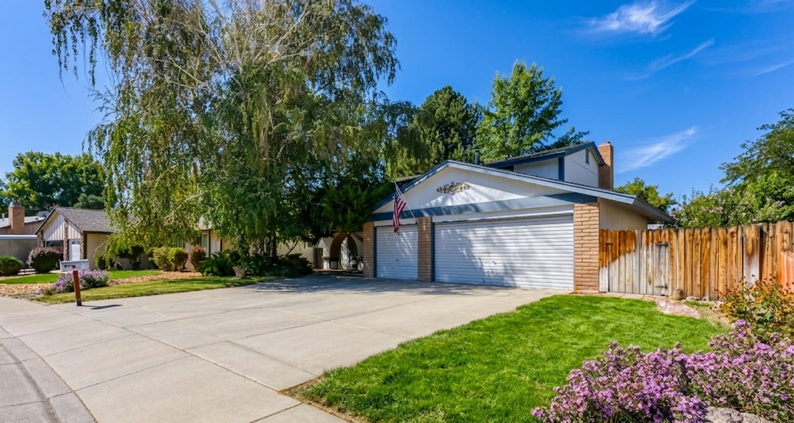 Split-level Sparks home with three-car garage under mature trees